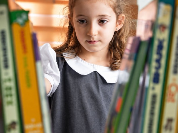 A student exploring the library at Happyhome